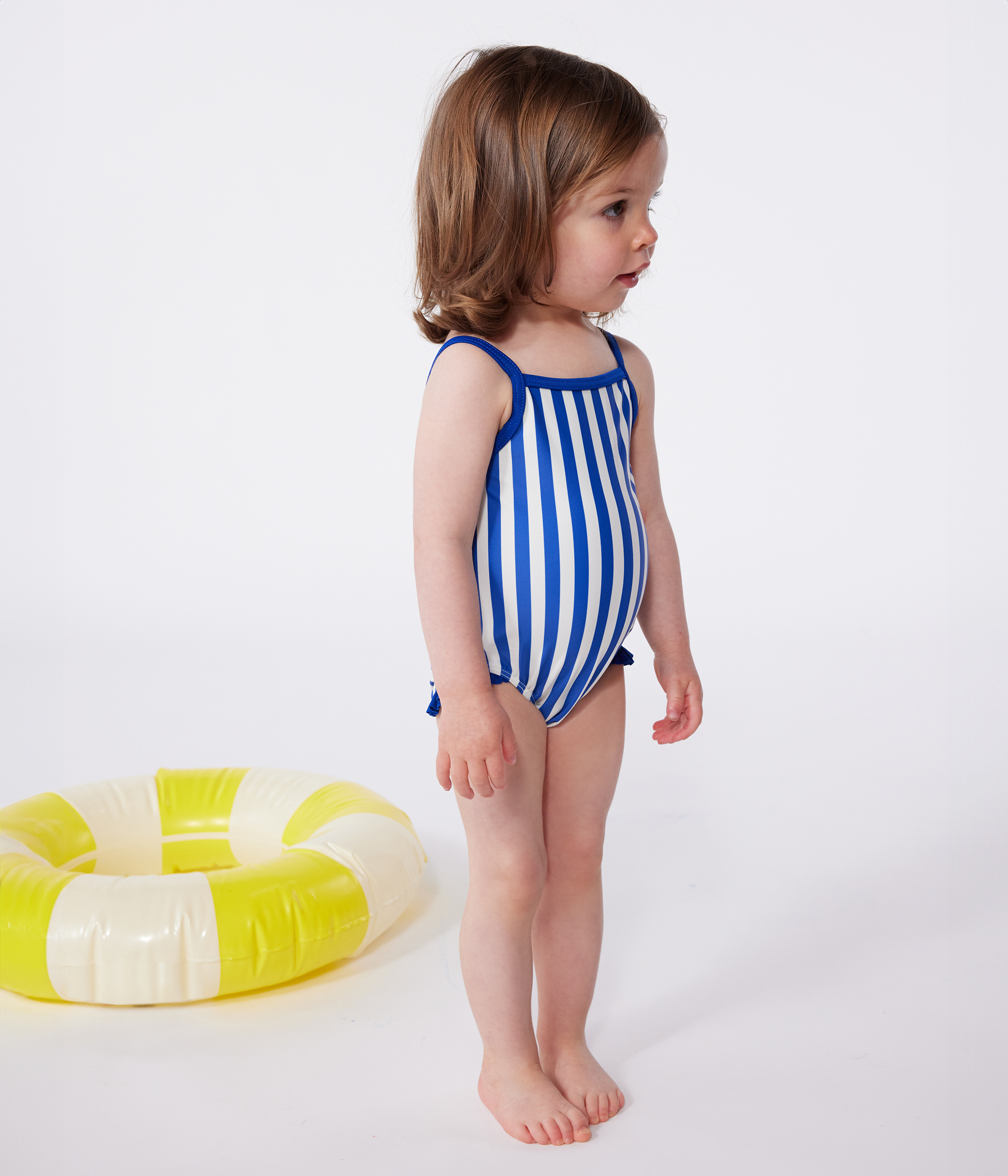 Babies' one-piece swimsuit with frills and a stripy print.
