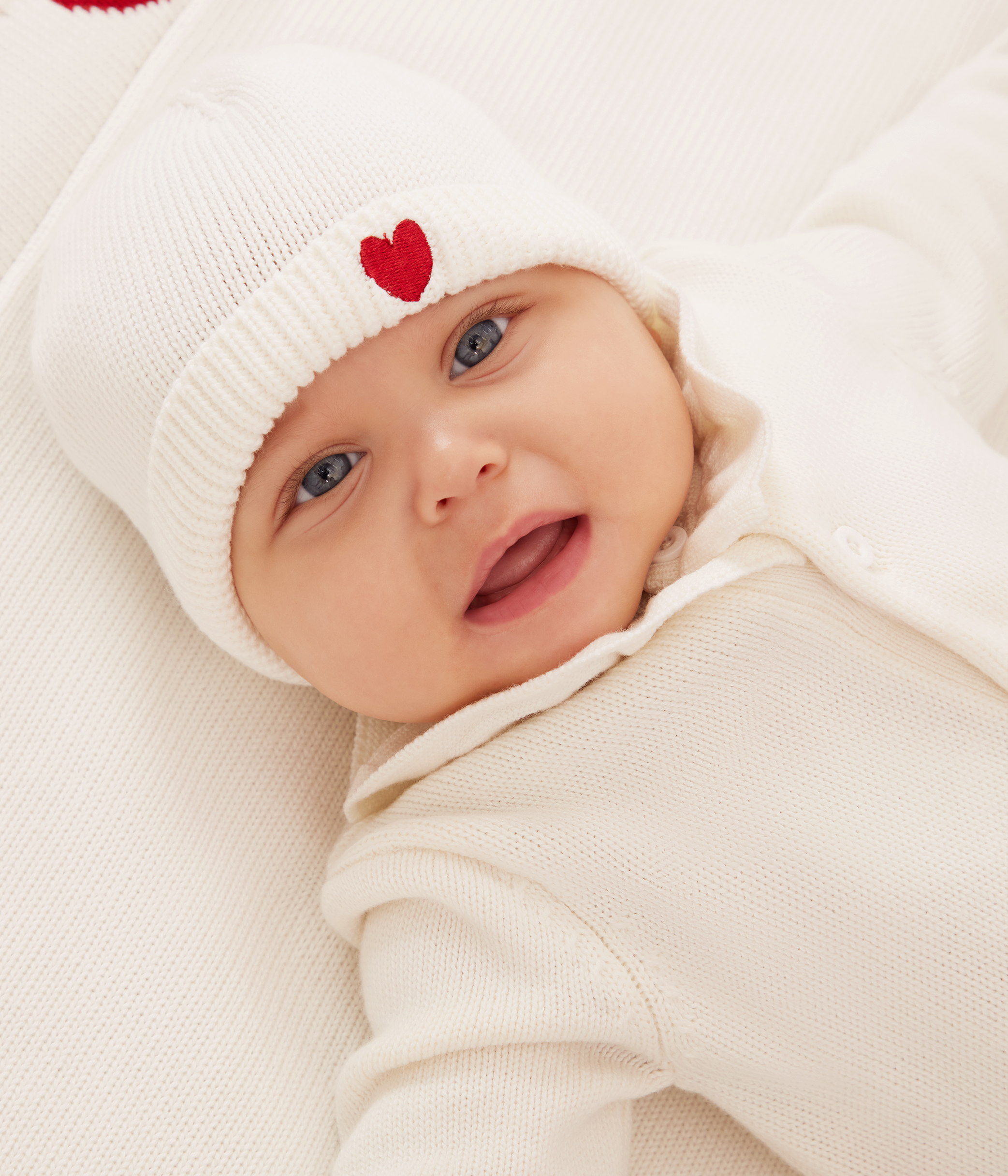 Babies' knitted playsuit with a collar and P'tit Cœur embroidery