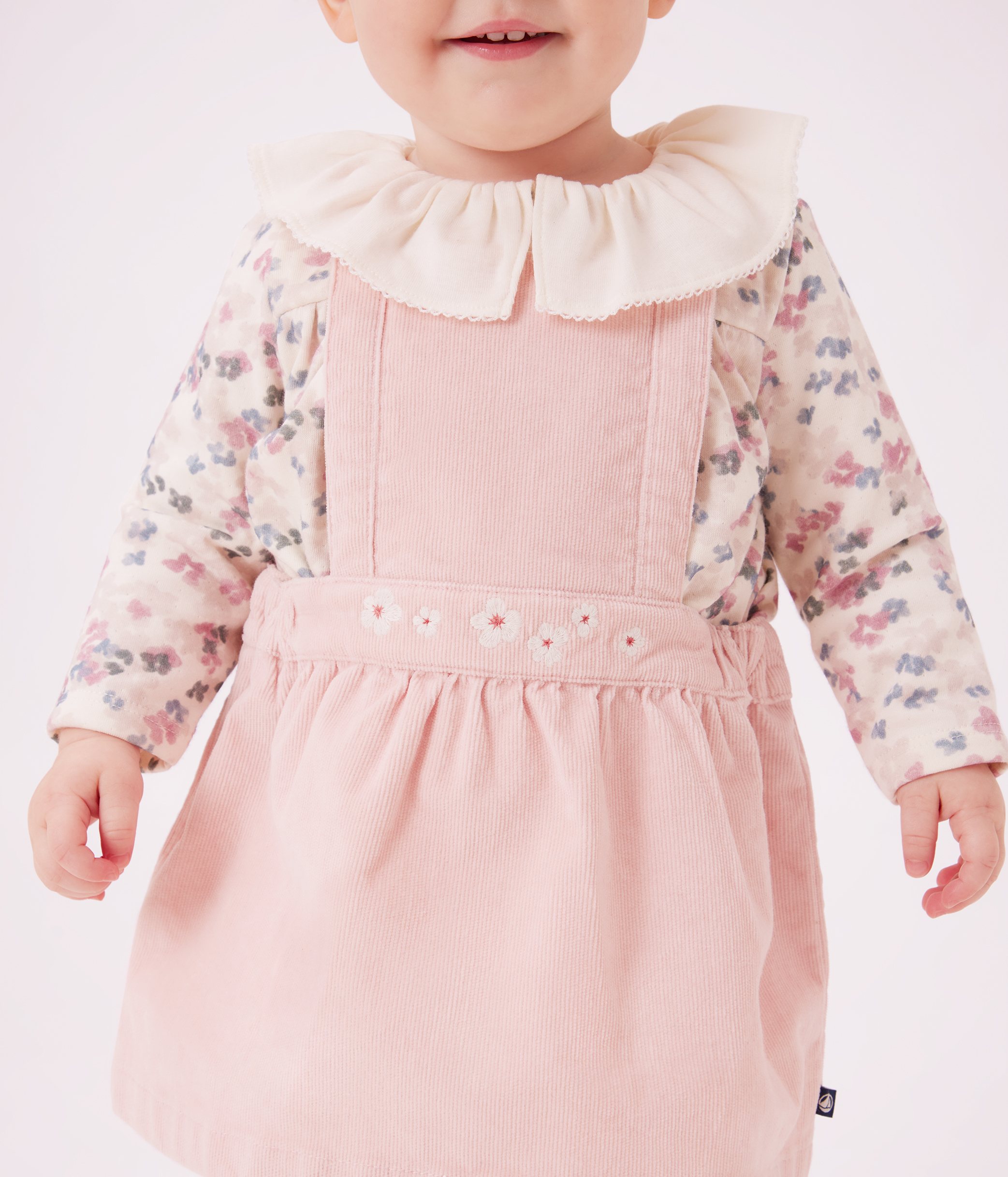 Babies' dress in corduroy embroidered with flowers on the waistband