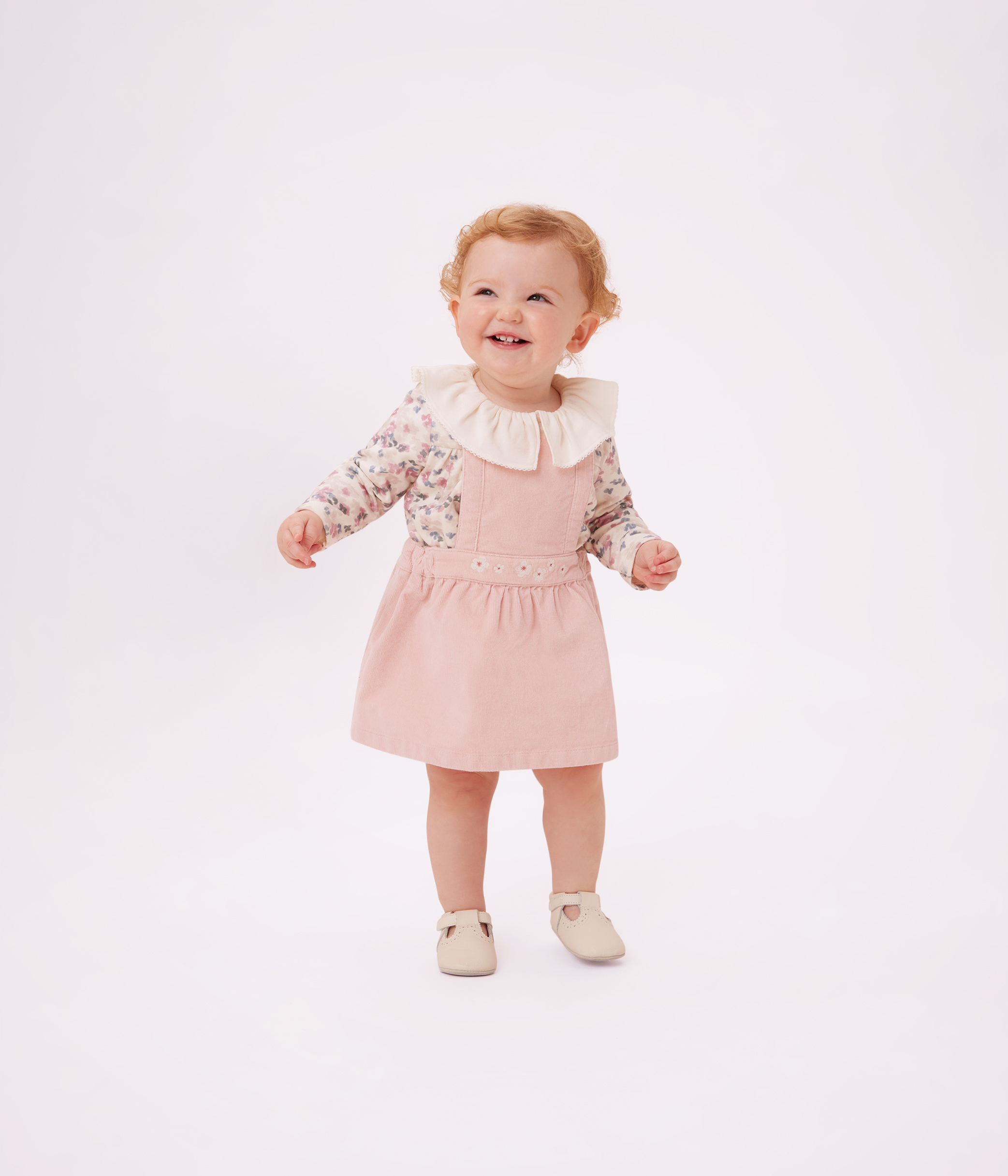 Babies' dress in corduroy embroidered with flowers on the waistband