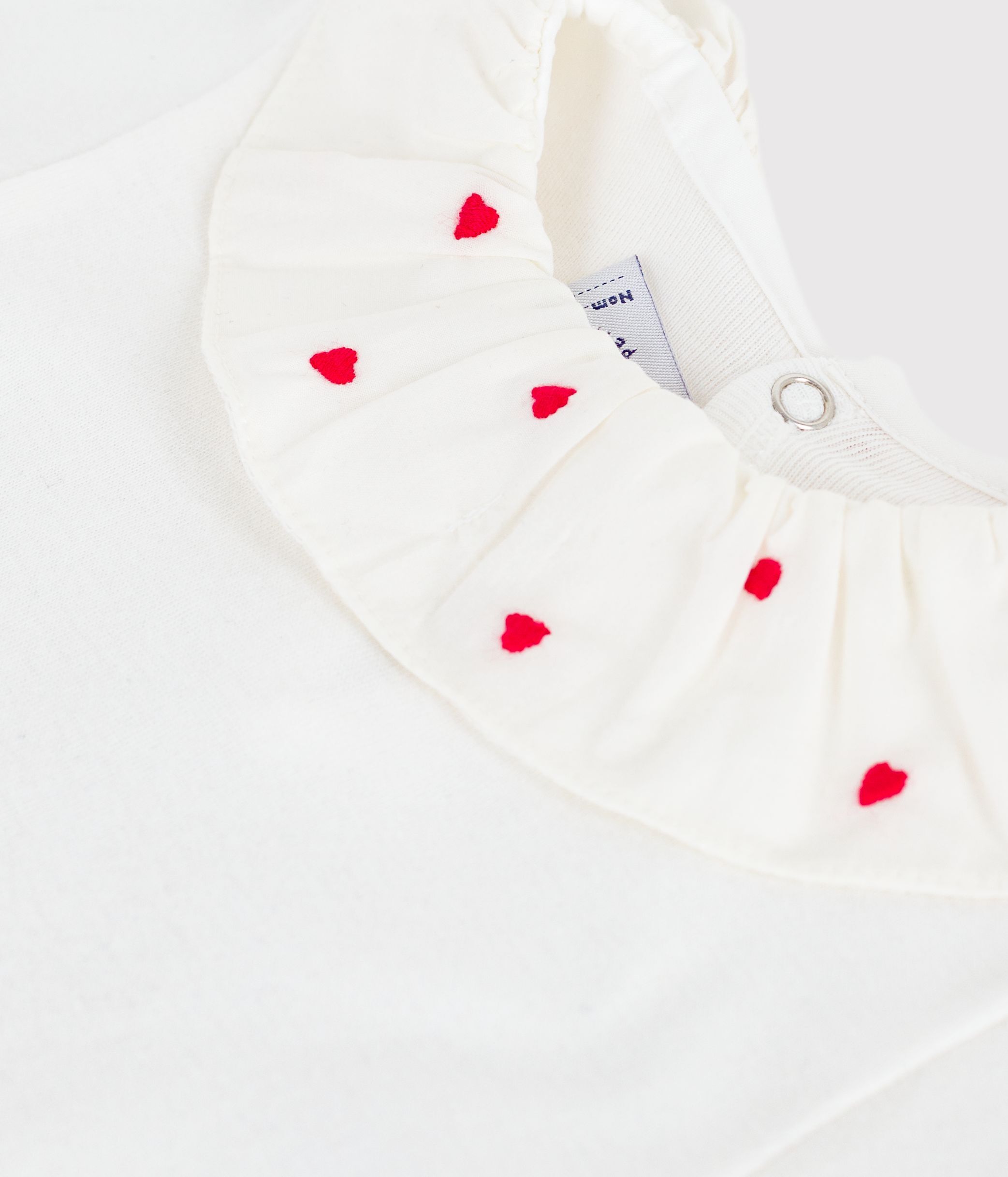 Babies' plain cotton body with an embroidered collar