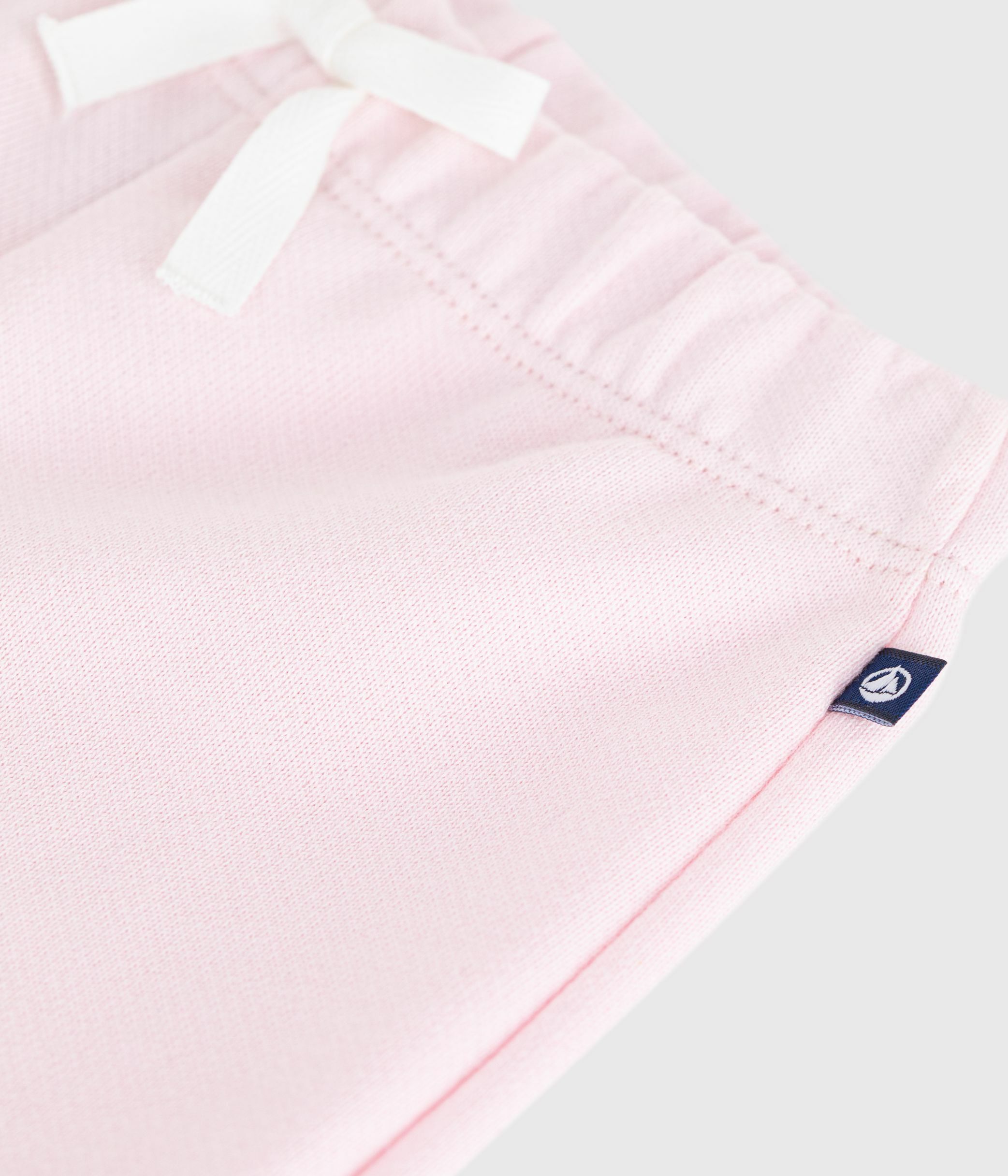 Babies' jogging bottoms in plain cotton